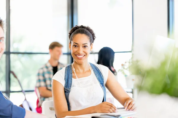 Portrait of smiling afro-american office worker sitting in offfice — Stock Photo, Image