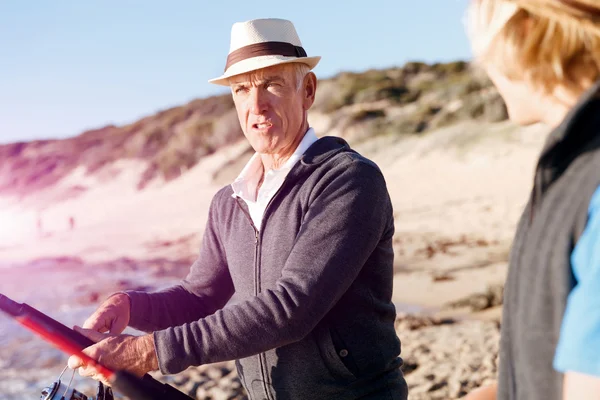 Senior man fishing with his grandson — Stock Photo, Image