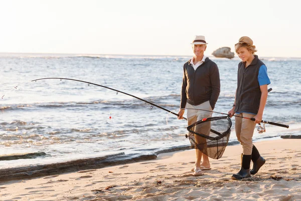 Senior man fishing with his grandson — Stock Photo, Image