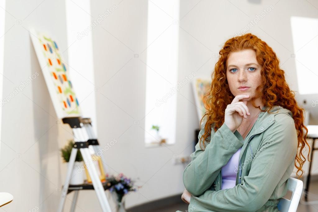 Young caucasian woman in art gallery front of  paintings