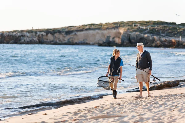 Senior man fishing with his grandson — Stock Photo, Image