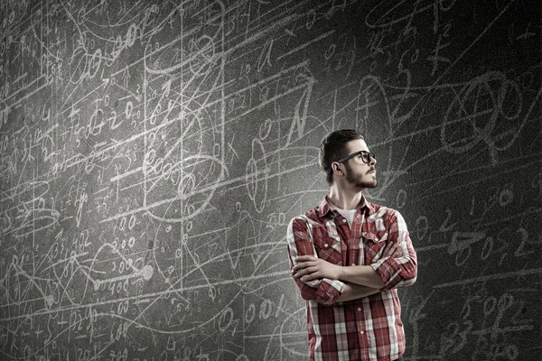 Student standing at blackboard . Mixed media — Stock Photo, Image
