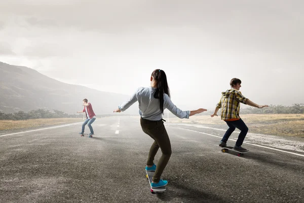 Teenagers ride skateboards . Mixed media — Stock Photo, Image