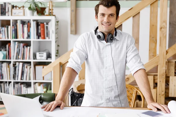 Young man standing in creative office — Stock Photo, Image