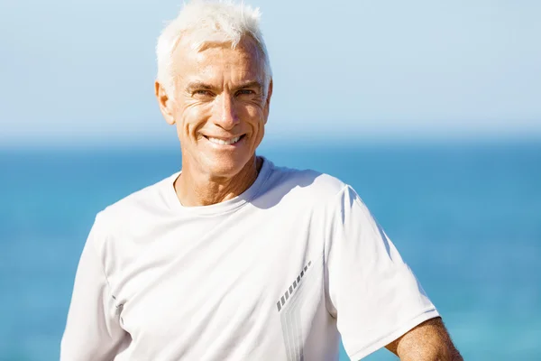 Man standing on beach in sports wear Stock Photo