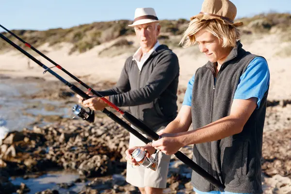 Senior man fishing with his grandson — Stock Photo, Image