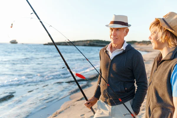 Uomo anziano pesca con suo nipote — Foto Stock