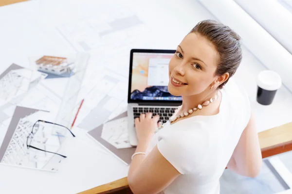Young woman architect in office — Stock Photo, Image