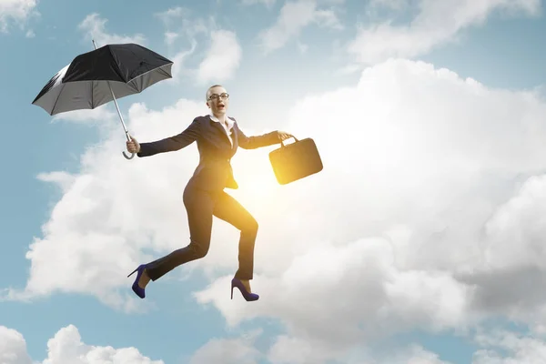 Jeune femme d'affaires marchant avec parapluie — Photo