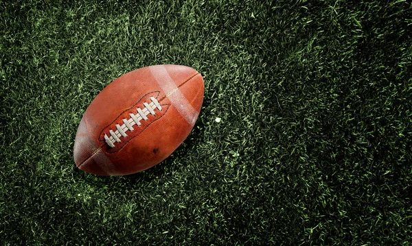 American football ball on grass background — Stock Photo, Image