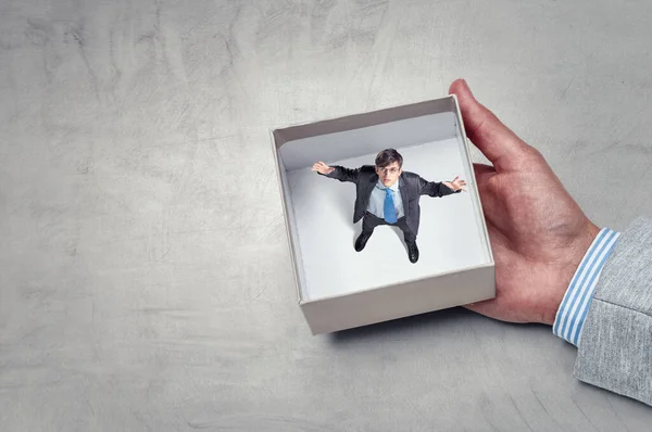 Businessman inside a box . Mixed media — Stock Photo, Image