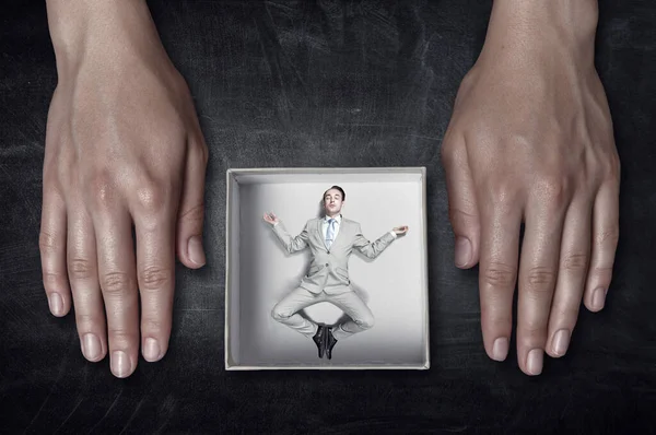 Businessman inside a box . Mixed media — Stock Photo, Image