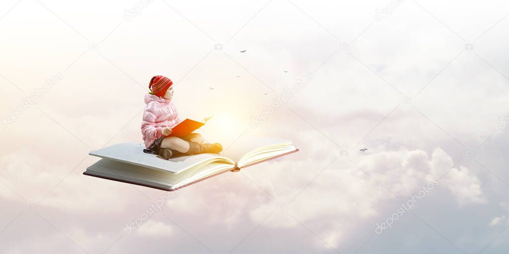 Little girl reading a book