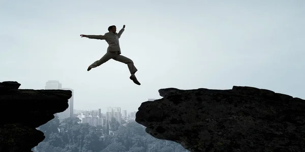 Jumping over precipice, challenge concept. — Stock Photo, Image