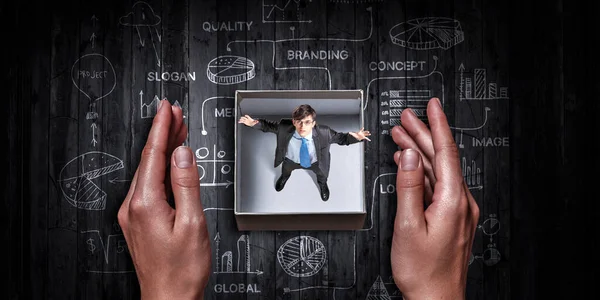 Empresário dentro de uma caixa. Meios mistos — Fotografia de Stock