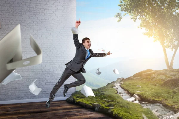 Happy businessman jumping high . Mixed media — Stock Photo, Image