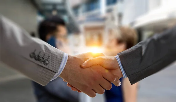 Partnership concept. Image of handshake . Mixed media . Mixed media — Stock Photo, Image