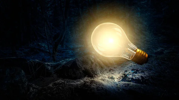 Huge light bulb glowing in the darkness — Stock Photo, Image