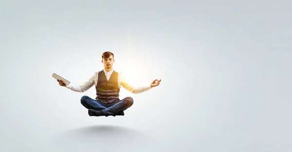 Business man doing yoga in lotus pose — Stock Photo, Image