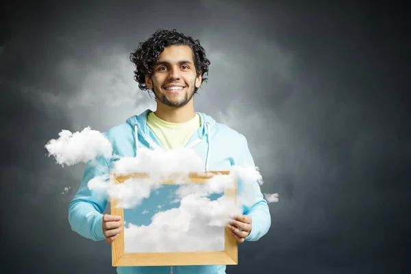 Muž držící rám s modrou oblohou a mraky. Smíšená média. Smíšená média — Stock fotografie