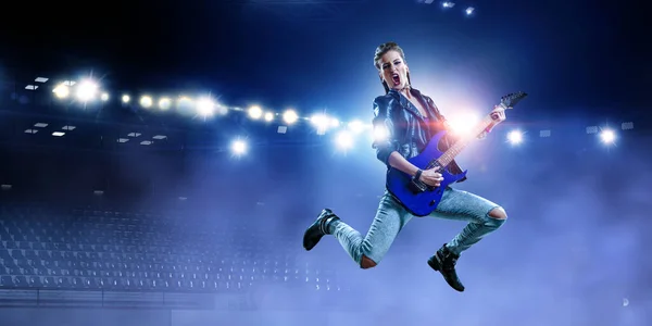 Young and beautiful rock girl playing the electric guitar — Stock Photo, Image