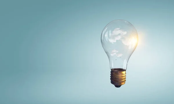 Light bulb on light blue background — Stock Photo, Image