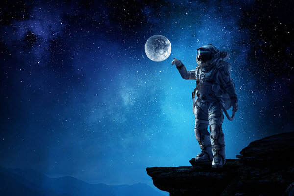 Astronaut walking on an unexplored planet. Mixed media