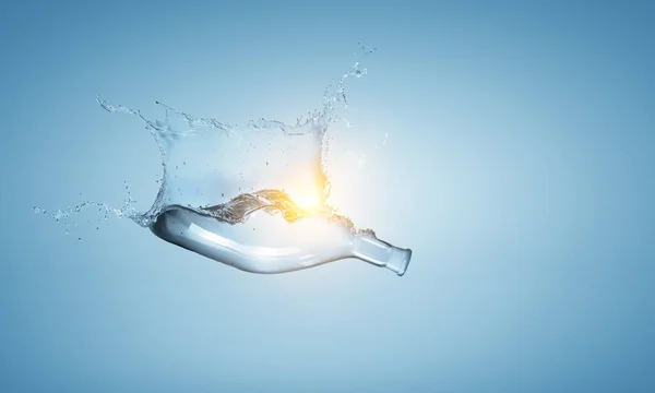 Water splash out of glass bottle — Stock Photo, Image