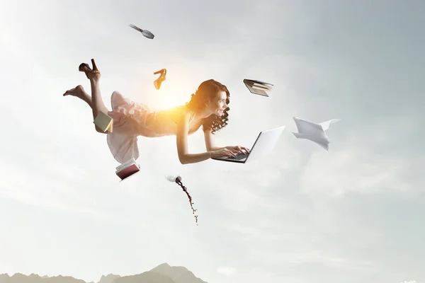 Young woman levitates while reading a book — Stock Photo, Image