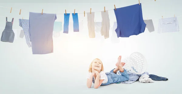 Happy little girl with washed clothes . Mixed media — Stock Photo, Image