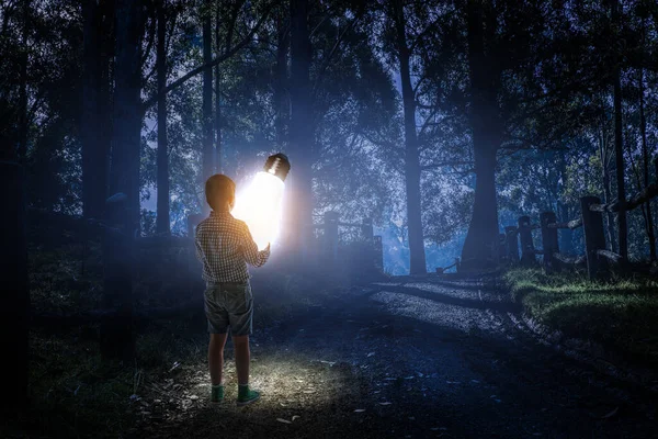 Boy with a glowing light bulb — Stock Photo, Image