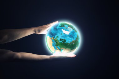 Dünya gezegeni tutan eller