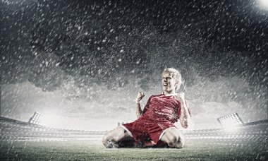 dizlerinin üzerinde duran futbolcu