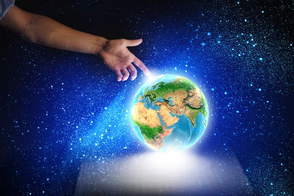 Human hand touching Earth planet with finger — Stock Photo, Image