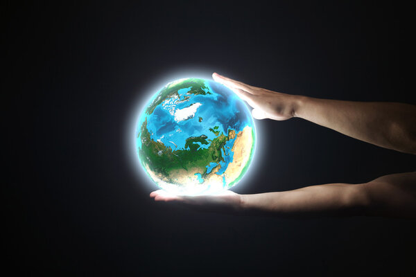 Human hand holding Earth planet