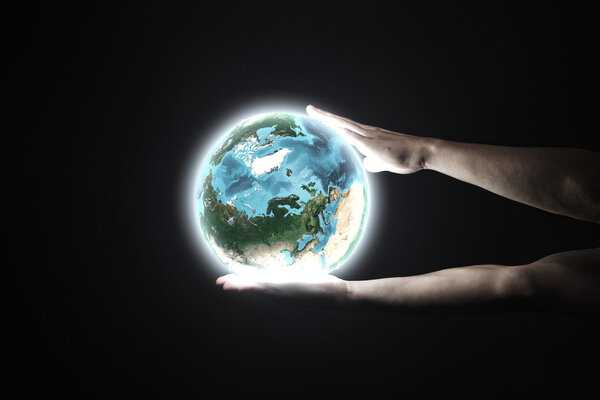Human hand holding Earth planet
