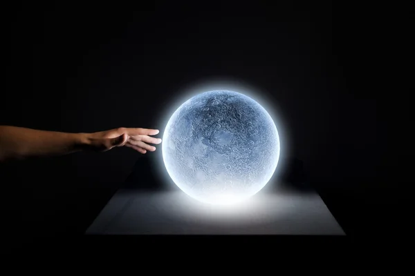 Human hand touching blue glowing moon — Stock Photo, Image