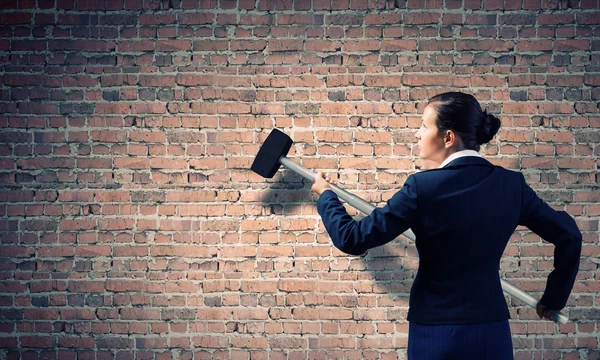 Businesswoman with hammer in hands — Stock Photo, Image