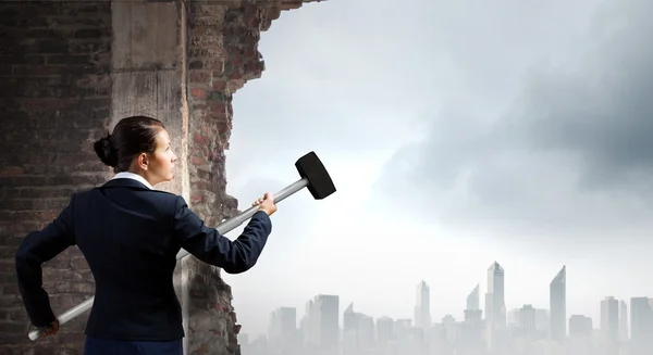 Businesswoman with hammer in hands — Stock Photo, Image