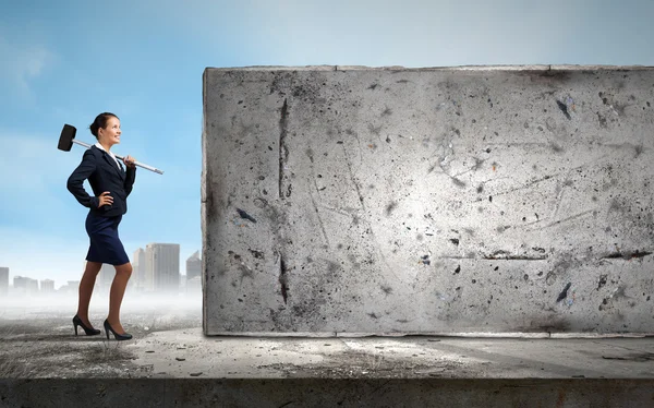 Businesswoman with hammer in hands — Stock Photo, Image