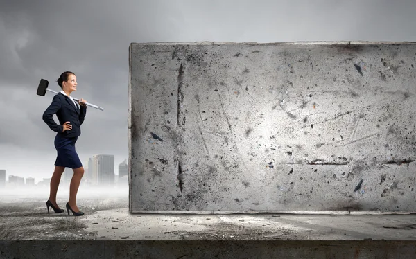 Businesswoman with hammer in hands — Stock Photo, Image