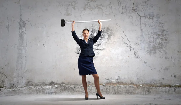 Businesswoman with hammer in hands — Stock Photo, Image