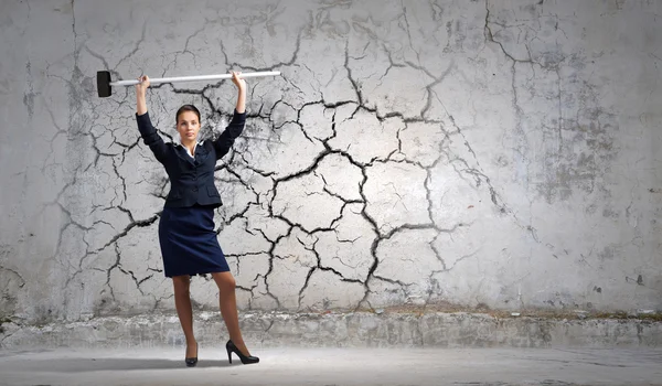 Businesswoman with hammer in hands — Stock Photo, Image