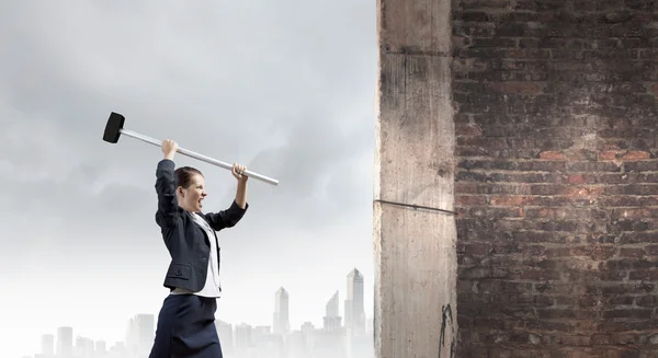 Businesswoman with hammer in hands — Stock Photo, Image