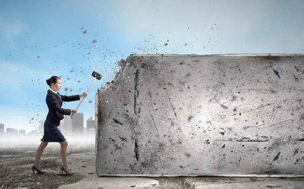 Businesswoman with hammer in hands — Stock Photo, Image