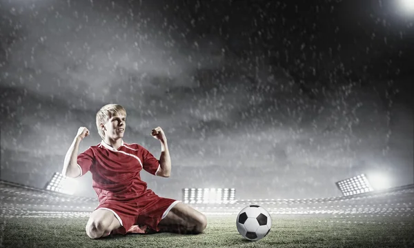 Football player standing on knees — Stock Photo, Image