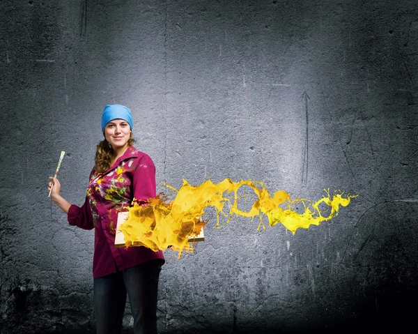 Painter holding frame with colorful splashes — Stock Photo, Image