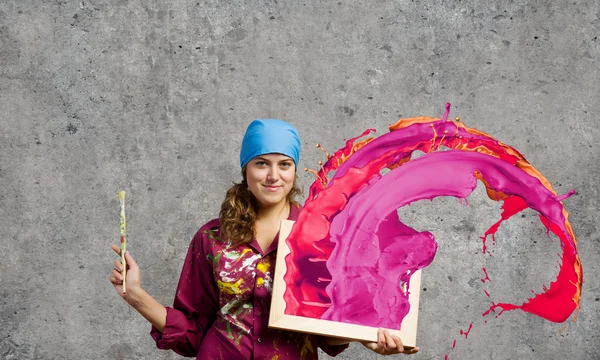 Pintor segurando quadro com salpicos coloridos — Fotografia de Stock