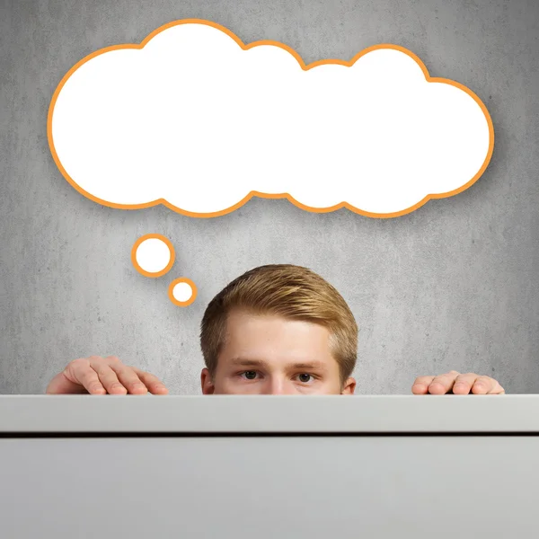 Man looking out from under table — Stock Photo, Image