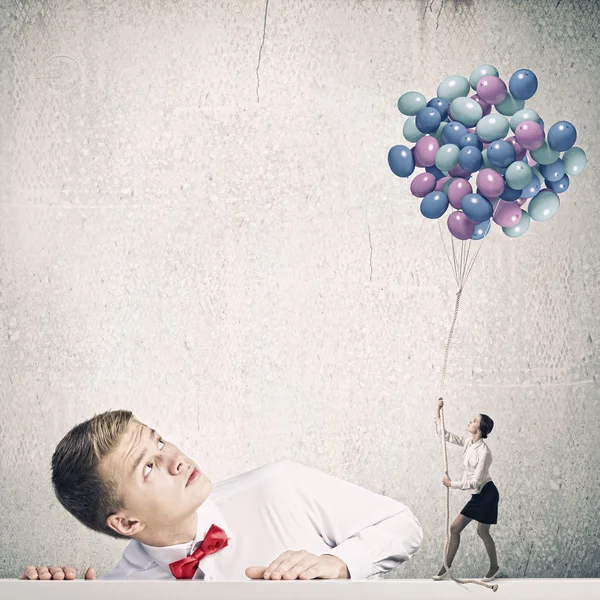 stock image Man looking at woman with balloons